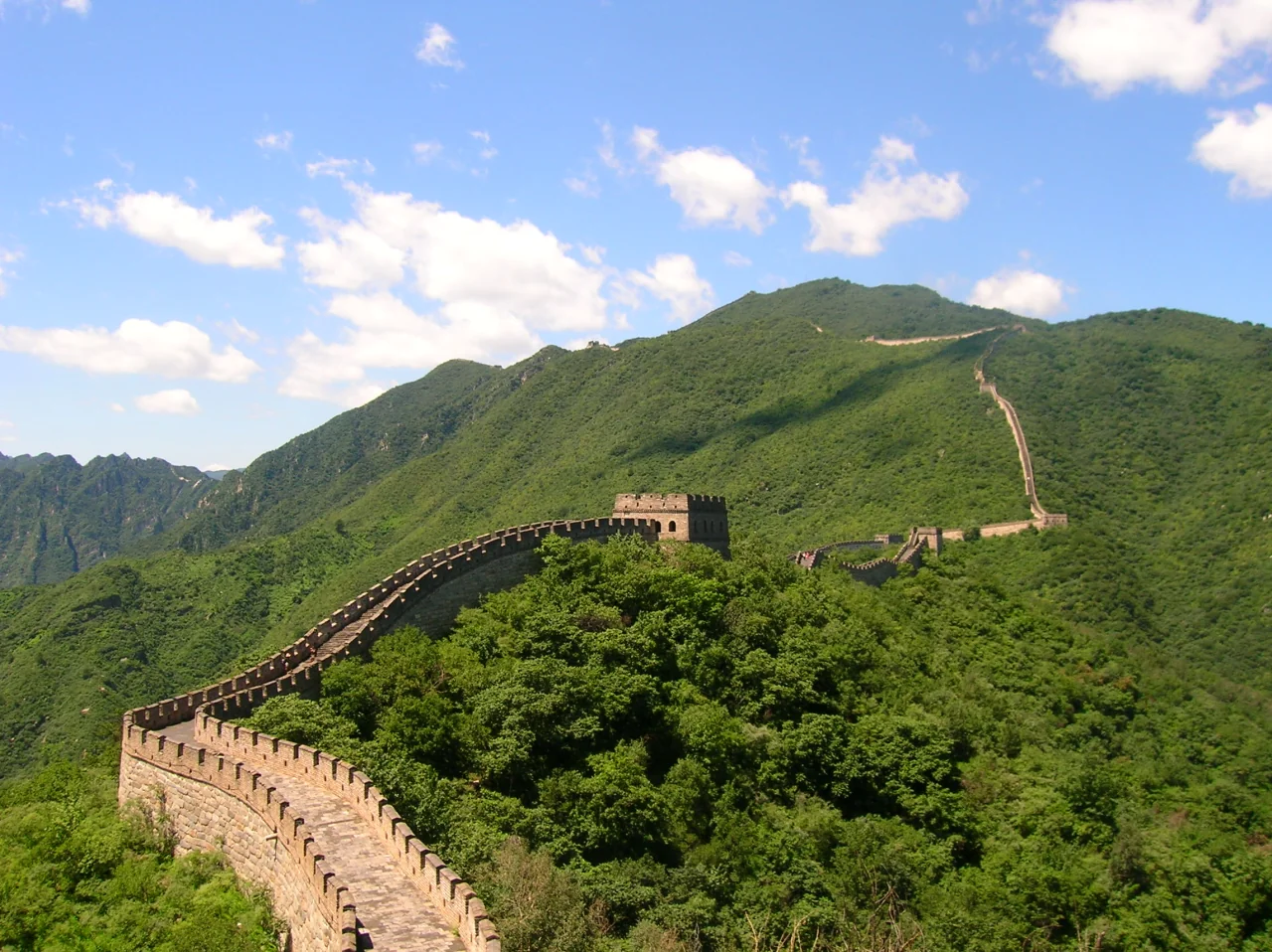 The Great Wall of China at Mutianyu, Huairou District, Beijing, with the surrounding forested mountains.