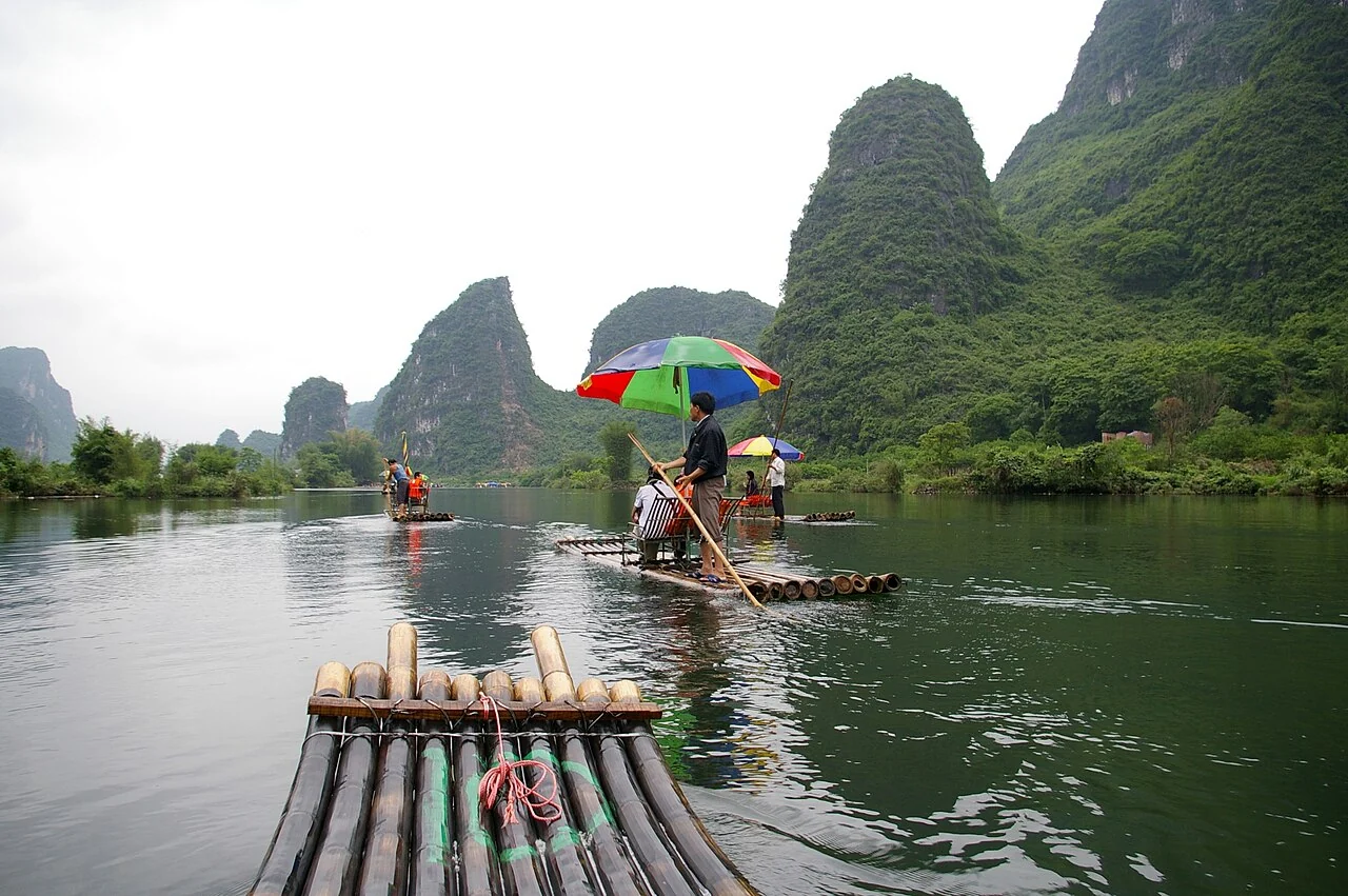 Bamboo rafts on the Yulong River beneath the karst peaks of Yangshuo, Guangxi, China.